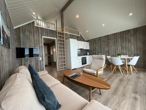 布倫尼的住宿－Norsk Havbrukssenter - Rorbuer，客厅配有沙发和桌子