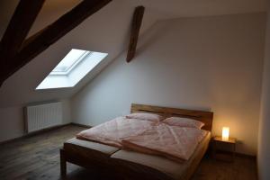 a bedroom with a bed and a window in a attic at Altes Pastorat in Kevelaer