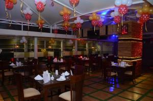 a dining room with tables and balloons on the ceiling at Hotel Ramaya in Gwalior