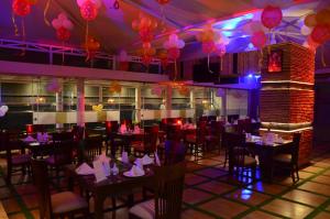 a dining room with tables and chairs and balloons at Hotel Ramaya in Gwalior