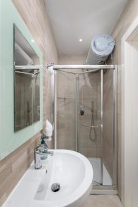 a bathroom with a shower and a white sink at Sea View Apartment 2 bedrooms 2 bathrooms, 2 minutes away from the sea in St Julian's