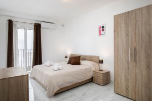 a bedroom with a large bed and a large window at Sea View Apartment 2 bedrooms 2 bathrooms, 2 minutes away from the sea in St Julian's