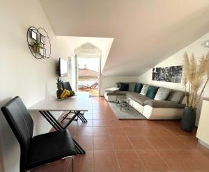 a living room with a couch and a table at Apartment Lady Daniela mit Meerblick in Lovran in Lovran