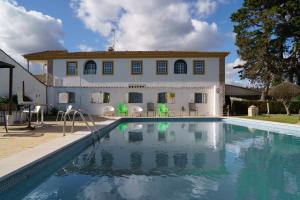 a house with a swimming pool in front of a house at Quinta de Santa Barbara in Constância