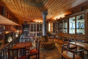 a room with a fireplace and a table and chairs at Quinta de Santa Barbara in Constância