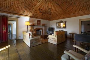 a living room with a couch and a fireplace at Quinta de Santa Barbara in Constância