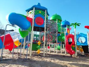 a playground with a bunch of different colored slides at Flaming - domki letniskowe in Rowy +11 photos