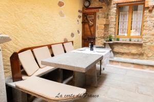 a table and chairs sitting on a patio at La Corte di Franco - 4 appartamenti sul lago in Brusimpiano