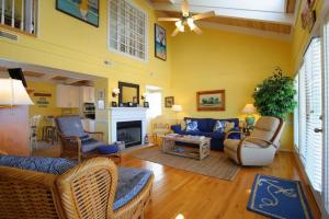 a living room with a blue couch and chairs at Holden Jeanie in Holden Beach