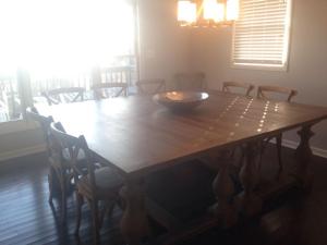 a wooden table with chairs and a bowl on top at Dune Deck South - Duplex in Holden Beach