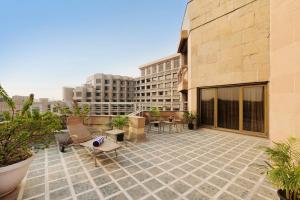 a patio with chairs and tables on a building at Hyatt Regency Delhi in New Delhi