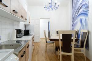 Una cocina con una mesa y sillas en una habitación. en Grand Central City Apartments Mitte Rosenthaler Platz, en Berlín