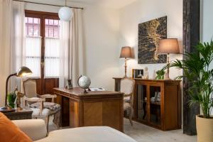 a living room with a desk and a chair at MonKeys Apartments Alameda House in Seville