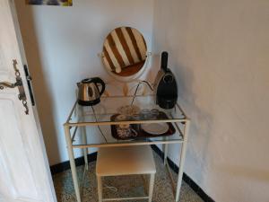 a shelf with pots and pans on it in a room at Mas Le Petit Nizon in Saint-Laurent-des-Arbres