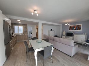 a living room with a white table and a couch at CASA ARBOL DE VIDA in Altea