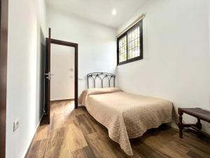 a bedroom with a bed and a window at Villa with private pool and great view of the Atlantic Ocean in Adeje