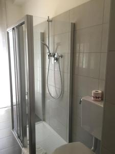a bathroom with a shower with a glass door at Sunday Apartments in Mestre