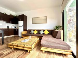 a living room with a couch and a coffee table at Villa with private pool and great view of the Atlantic Ocean in Adeje