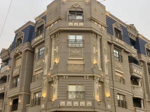 a tall building with lights on the side of it at Locanda Museum Hotel in Giza