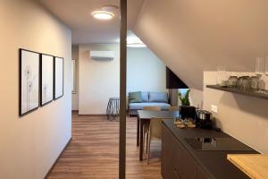 a kitchen and a living room with a table at Trautes Quartier in Bad Gleichenberg