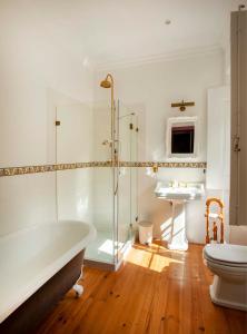 a bathroom with a tub and a toilet and a sink at Palácio de Sintra Boutique House in Sintra