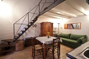 a living room with a table and a green couch at 4Roomsrelax in Catania