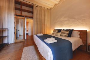 ein Schlafzimmer mit einem großen Bett mit Handtüchern darauf in der Unterkunft Bravissimo Carrer Nou, Cosy 2-bedroom apartment in Girona