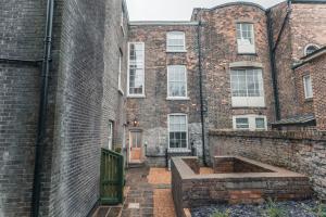 a brick building with a courtyard in front of it at Clarence Street Town House in Liverpool