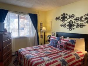 ein Schlafzimmer mit einem Bett mit einer Decke darauf in der Unterkunft Yellow Rose in Tucumcari