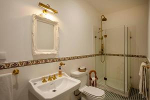 a bathroom with a sink and a toilet and a shower at Palácio de Sintra Boutique House in Sintra +32 photos