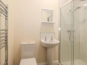 a bathroom with a toilet and a sink and a shower at Pond Cottage in Alnwick +18 photos