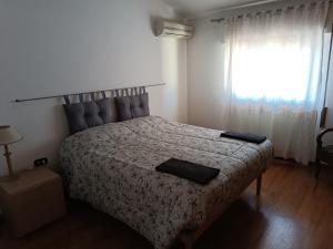 a bedroom with a bed and a window at Sea Breeze in Viareggio