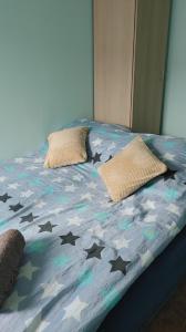 a bed in a room with stars on it at Hostel u Misiów in Suwałki