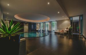 a person sitting on a couch in a living room at A-ROSA Collection Hotel Ceres am Meer in Binz