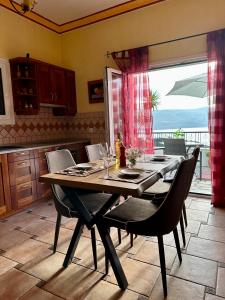a dining room with a table and chairs and a window at Aegean Blue House - Spectacular Seaview in Kalámion