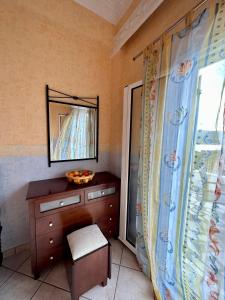 a bathroom with a dresser and a mirror and a window at Aegean Blue House - Spectacular Seaview in Kalámion
