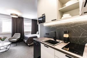TV a/nebo společenská místnost v ubytování K20 Apartamenty Łódź - Dostęp na Kod