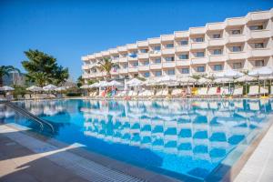 a large swimming pool in front of a hotel at IALYSSOS BAY HOTEL in Ialysos +28 photos