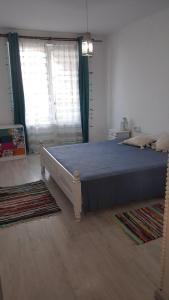 a bedroom with a large bed and a window at Monastery Apartment 14, St. Vlas in Sveti Vlas