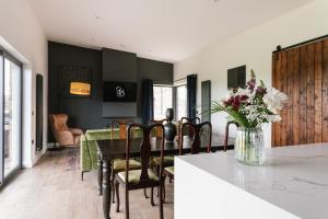 a kitchen and dining room with a table and chairs at The Barn at Corrstown Village in Portrush