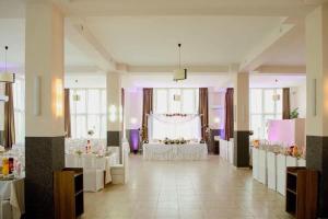 a large room with a table and a wedding at Pensiunea Oșencuța in Talmesch +36 photos