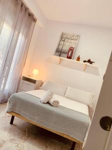 Ένα ή περισσότερα κρεβάτια σε δωμάτιο στο APARTAMENTOS PINTOR ZURBARAN
