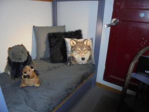 two stuffed animals are sitting on a bed at MON SKI A LA PLAGNE - PLAGNE BELLECOTE Résidence 3000 in Plagne Bellecote