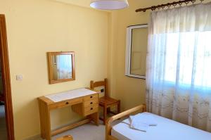 a small room with a table and a mirror at Spiros Apartments - Agios Gordios Beach, Corfu, Greece in Agios Gordios
