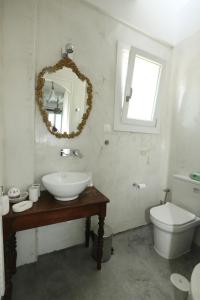 a bathroom with a sink and a toilet and a mirror at Onverra Villa in Rózia