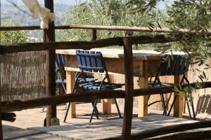 a wooden table and chairs on a wooden deck at Settignano Tuscany Homes in Settignano