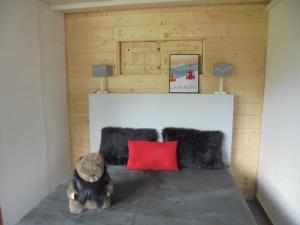 a teddy bear sitting on a bed in a room at MON SKI A LA PLAGNE - PLAGNE BELLECOTE Résidence 3000 in Plagne Bellecote