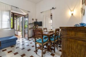 a dining room with a table and chairs at Residence Capo Caccia Alghero in Alghero