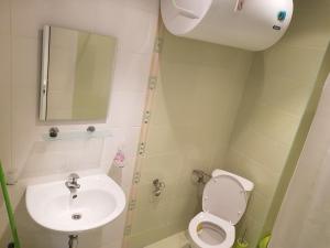a small bathroom with a toilet and a sink at Midia Grand Rezort in Aheloy