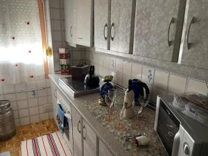 a kitchen with a counter with wine glasses on it at Encantador apartamento acogedor in Tarifa